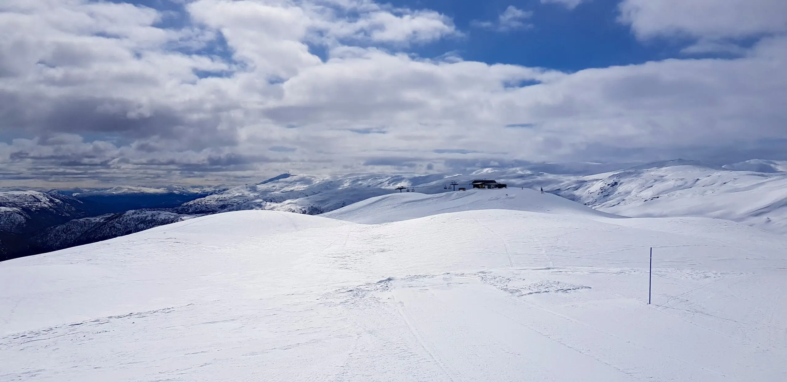 Panorama view on snow mountains, blue sky and white clouds, skiing in Myrkdalen, Norway