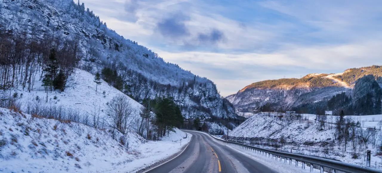 Winding road in the mountains during winter sunet in Voss, Norway