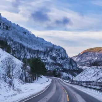 Winding road in the mountains during winter sunet in Voss, Norway