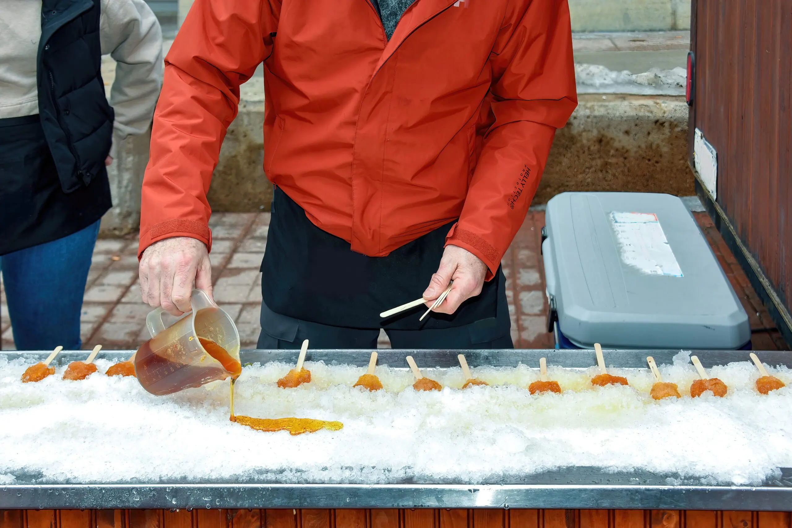 Man,Creates,Maple,Taffy,In,The,Snow.,The,Seasonal,Treat