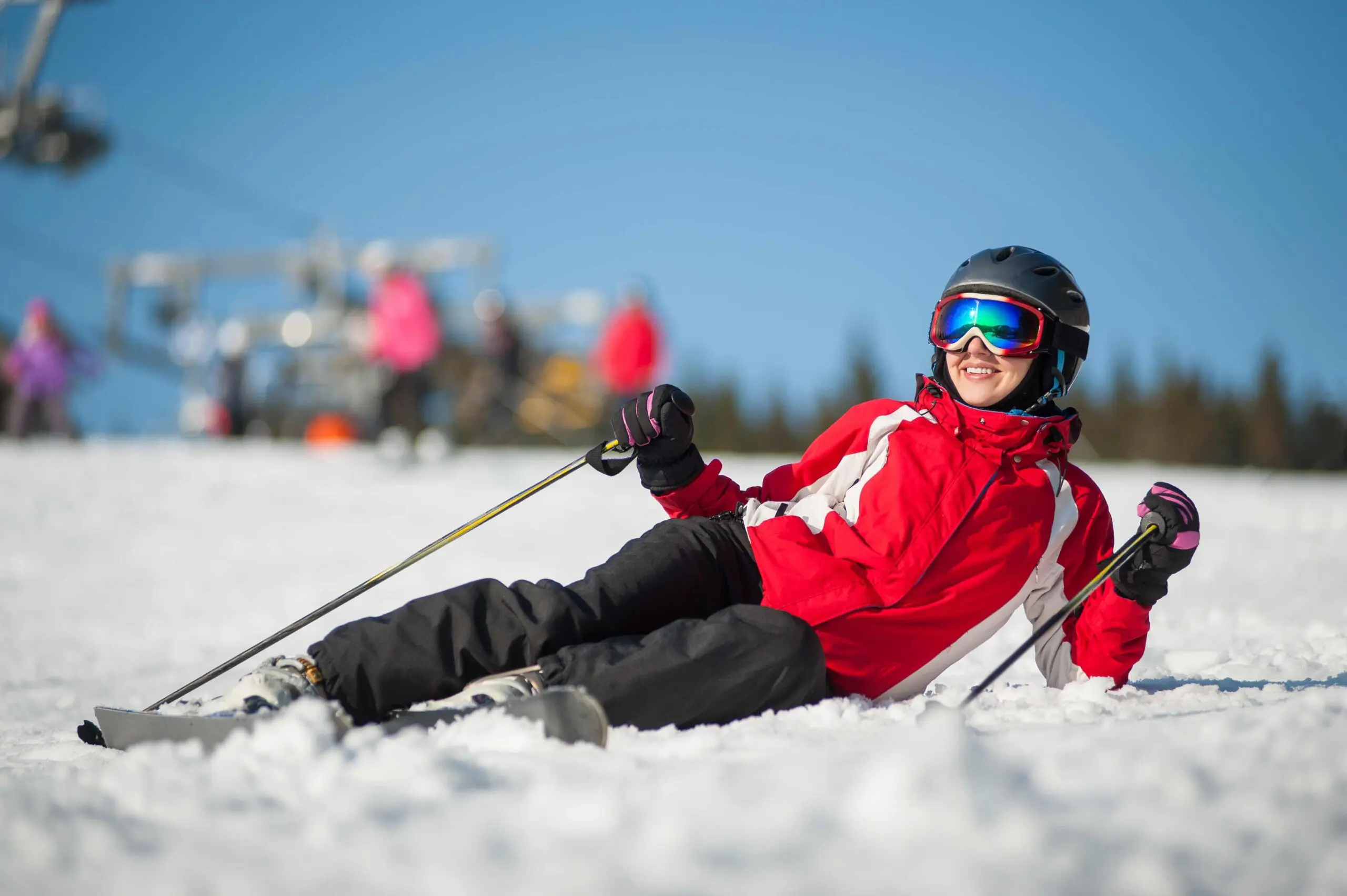 Woman skier with ski at winter resort in sunny day Mont St Anne