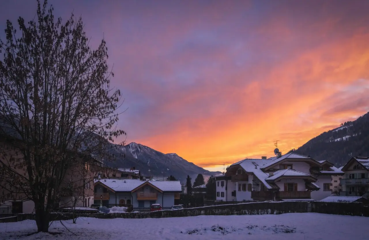 Town of Pinzolo under the snow at sunset. Trento Autonomous Province. Trentino Region, Upper Adige, Italy.