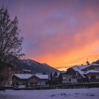 Town of Pinzolo under the snow at sunset. Trento Autonomous Province. Trentino Region, Upper Adige, Italy.