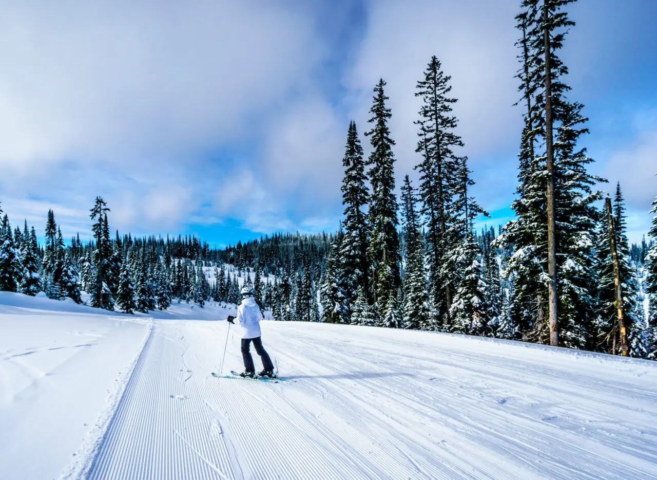 Woman Skiing in a Winter Landscape on the Ski Hills of Sun Peaks in the Shuswap Highlands of central British Columbia, Canada